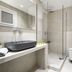Oniropetra Apartaments in Plintri bathroom with walk-in shower, wall-mounted sink and toilet
