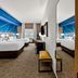 Comfort Inn & Suites Donna guest room with two beds, mirrored wall, and city view window