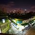 Urban Hostel Bangkok rooftop city view at night over Bangkok skyline and street below