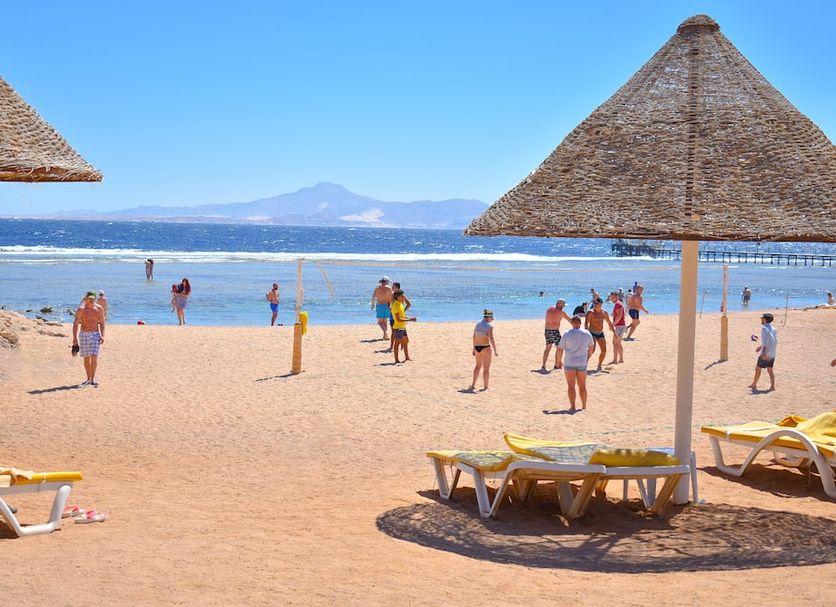 Parrotel Aqua Park Resort in Sharm el-Sheikh beachfront with lounge chairs, umbrellas and sea view