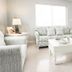 Ocean Eleven Suites in New Smyrna Beach living room with sofa, armchairs, coffee table and wall-mounted TV