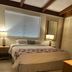 Tropical Resort & Marina on Lake Beresford room with bed, bedside lamps and window blinds in DeLand