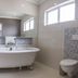 Sea Breeze Guesthouse, Swakopmund: spacious bathroom with freestanding tub, glass shower and double vanity
