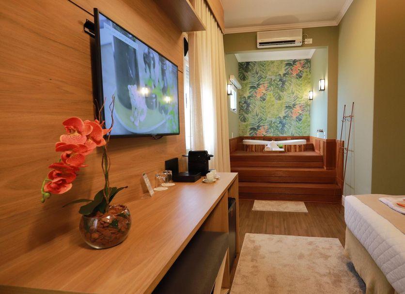 Ls Villas Tranquillità in Aguas De Sao Pedro room with TV, sofa nook, and twin beds