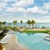 Rosewood Mayakoba in Playa del Carmen with a beachfront infinity pool, loungers, palm trees and ocean view