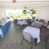 Cyclades Beach Apartments in Platis Gialos: covered seaside terrace with tables, chairs, and ocean view