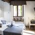 Do-Do Navona Suites room in Rome with a bed, desk, wall-mounted TV, and window seat
