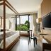 Plataran Ubud Hotel And Spa room with four-poster bed, desk, and garden view in Denpasar