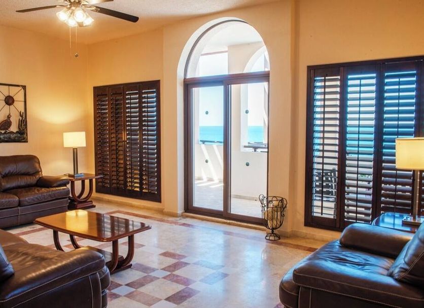Sea of Cortez Beach Club San Carlos living room with ocean view through arched balcony doors