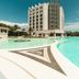 Delta Hotels by Marriott Olbia Sardinia in Olbia with a large outdoor pool beside a modern tower