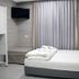 Hi Rabin - Jerusalem Hostel room with single bed, TV and curtained window in Jerusalem