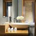 Suite Art Navona in Rome bathroom with vessel sink, toiletries, mirror and bedroom beyond