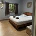 Aonang Sr Bungalow in Ao Nang bedroom with double bed, window, fan and gray walls