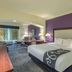 La Quinta Inn & Suites by Wyndham Loveland/Estes Park guest room with king bed and seating area in Loveland