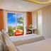 Aston Bogor Hotel and Resort room with twin beds, TV, and balcony view of greenery in Bogor