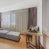 Lavande Hotels Nanjing Confucius Temple Daguang Road suite with gray sectional sofa and round table in Nanjing