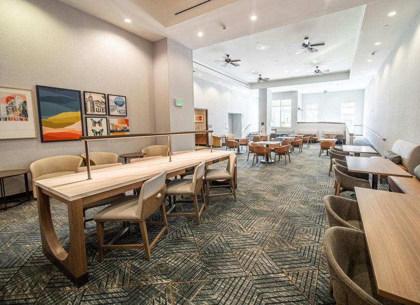 Homewood Suites by Hilton Rochester Mayo Clinic Area/Saint Marys lounge with tables and chairs