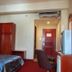 Great Eastern Hotel Quezon City guest room in Manila with bed, wardrobe, desk chair and air conditioner