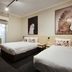 Nightcap at the Charles Hotel in Wollongong guest room with two beds and bird artwork