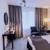 Vann Spa Hotell & Konferens in Brastad guest room with bed, chairs, lamp and window curtains