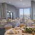 Holiday Inn Express & Suites Ventura Harbor banquet room with round dining tables and marina views in Ventura