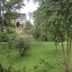 Hostal Bogotá Real in Bogotá with a green landscaped garden and trees