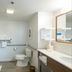 Hampton Inn and Suites Jamestown bathroom with walk-in shower, toilet, vanity and grab bars