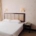 Lvjing International Hotel, Taizhou guest room with king bed, bedside lamps and window light