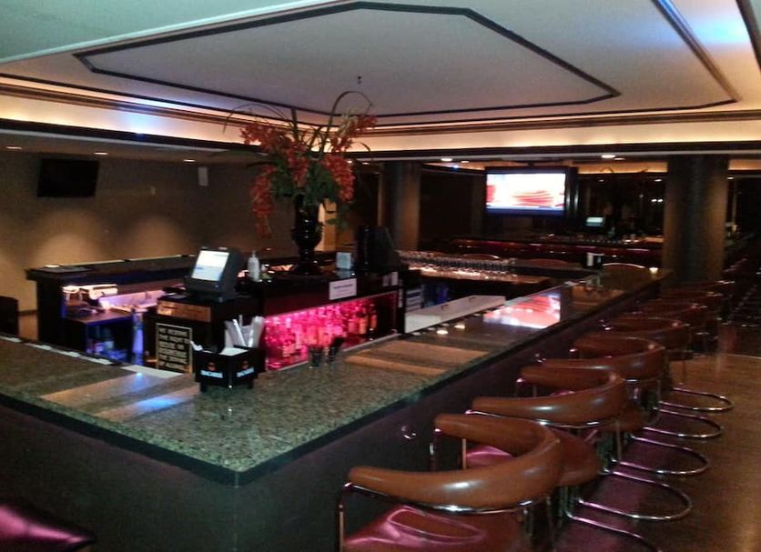 New Hope Inn & Suites bar area in New Hope with high stools and pink-lit counter
