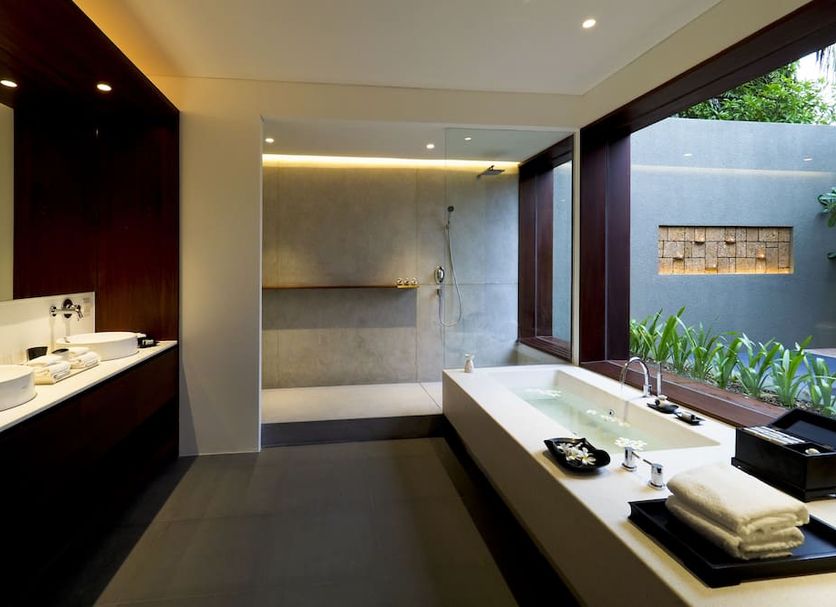 The Bale Phnom Penh by LifestyleRetreats bathroom with double sink vanity, soaking tub and garden view, Phnom Penh