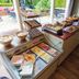 Hotel de Stoppelberg in Beekbergen breakfast buffet with pastries, fruit and cold items by patio doors