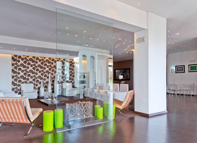 Mediterranea Hotel & Convention Center Salerno lobby with modern seating and glass partition