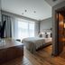 Balvanyos Resort in Baile Balvanyos: modern guest room with bed, wood floors, and bathroom entry