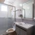 Sipadan Inn 1 Semporna bathroom with shower, toilet, sink and wall mirror