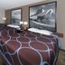 Super 8 by Wyndham Keokuk guest room with two beds, window, and framed wall art
