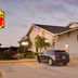Super 8 by Wyndham Keokuk exterior with parking lot and entrance at dusk