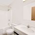 Super 8 by Wyndham Keokuk bathroom with tub-shower, toilet and vanity