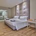 Água Hotels Mondim de Basto room with king bed, desk, and view into a bathroom
