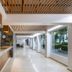 Hotel Villa Varadero in Nuevo Vallarta lobby with long reception desk, wood slat ceiling and bright corridor