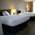 Heritage Inn & Suites by Capital O Baton Rouge I 10 room with two beds, desk and window curtains