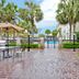 Hampton Inn & Suites Charleston/West Ashley patio with palm trees and a pool view in Charleston