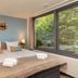Center Parcs De Vossemeren in Lommel, bedroom with twin bed, large window and forest view