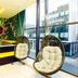 The Shankly Hotel Liverpool lounge with hanging chairs, neon decor and city view