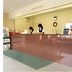 Hotel Shin-ei reception desk in Toyota with staff and floral arrangement