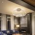 Hyatt Place South Reno lounge with blue velvet sofa, patterned rug, modern chandelier and fireplace