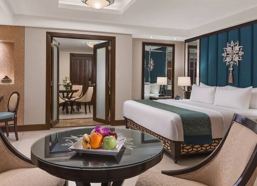 Henann Regency Resort & Spa Boracay suite with king bed, seating area, and table centerpiece