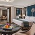 Henann Regency Resort & Spa Boracay suite with king bed, seating area, and table centerpiece