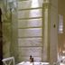Hotel Gargallo in Siracusa: candlelit stone corridor with stairs, arched passageway and dining tables
