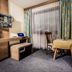 Pension Kreuzjoch in Zell am Ziller room with desk, chair, table, and large window with curtains
