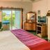 Sea Cliff Gardens Bed & Breakfast Port Angeles room with king bed, TV, dresser and ocean-view patio